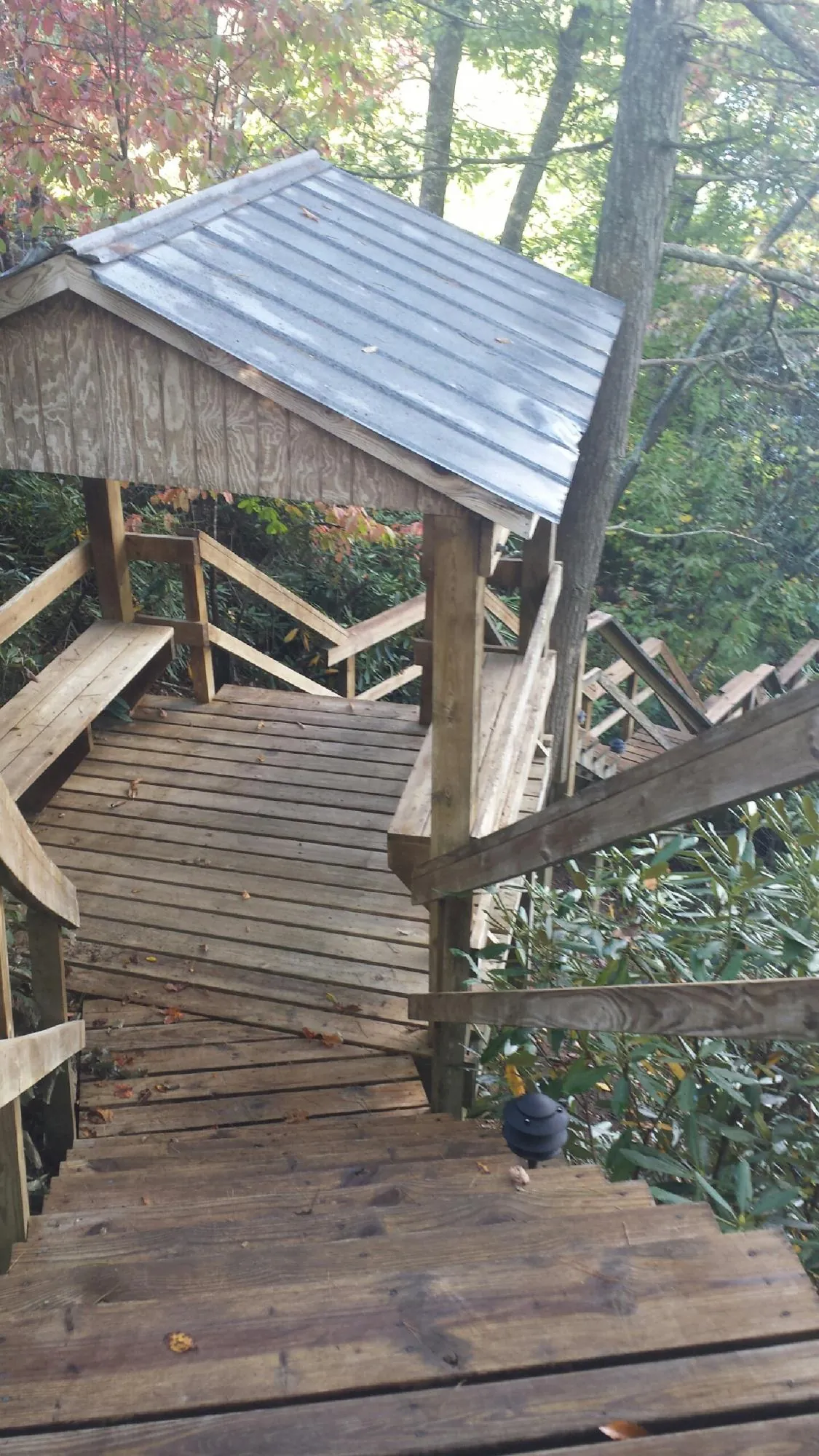 Metal roofed shelter over wooden steps on a wooded walkway — Skylight Repair & Installation work by our crew in Ballston Lake