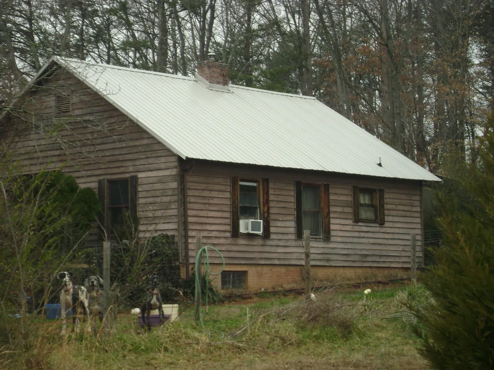 White metal roof on an old wood sided farmhouse, from a Metal Roof Installation job in Ballston Lake